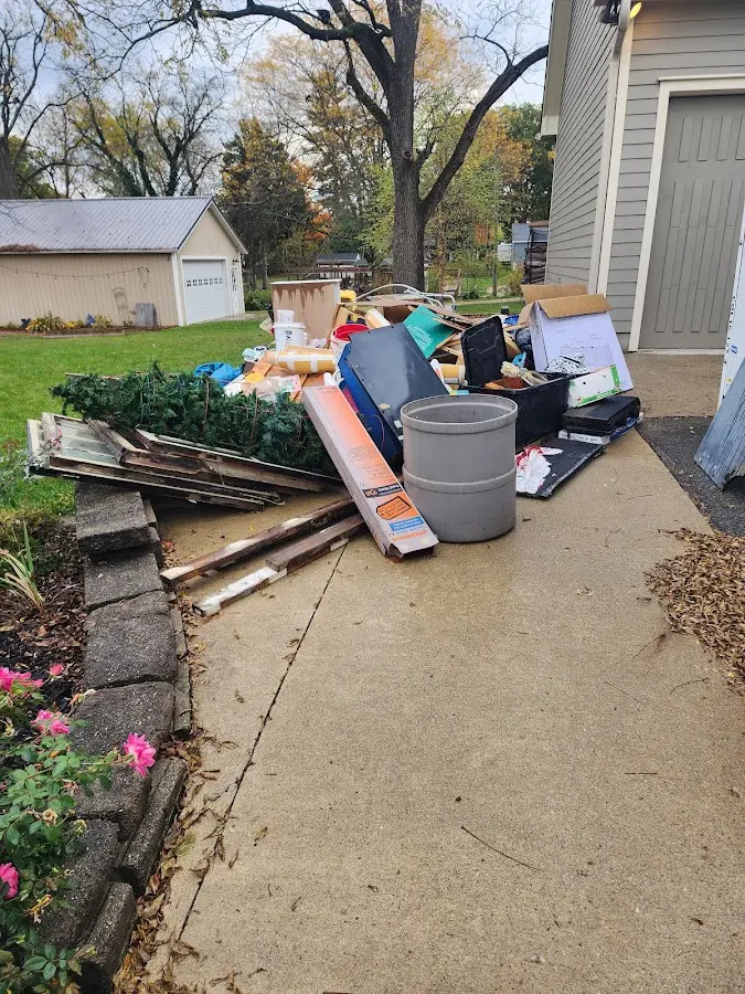 Dumpster being loaded with debris for 12 Yard Dumpster Rental in Pineville